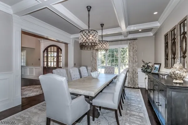 a view of a dining room with furniture and chandelier