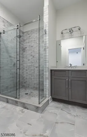 a bathroom with a shower sink and mirror
