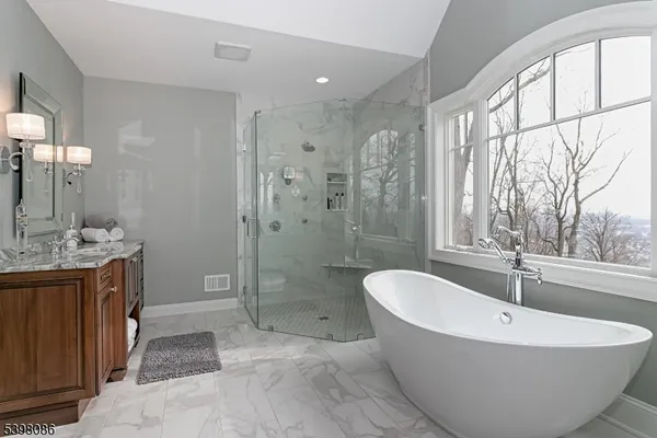 a spacious bathroom with a large tub shower and sink