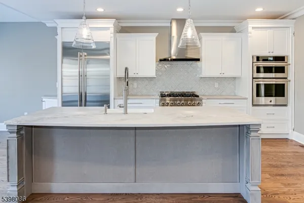 a kitchen with stainless steel appliances granite countertop a sink and a refrigerator