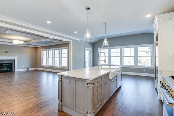 a kitchen with stainless steel appliances granite countertop a stove and wooden floor
