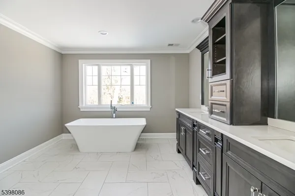 a spacious bathroom with a bathtub sink and mirror