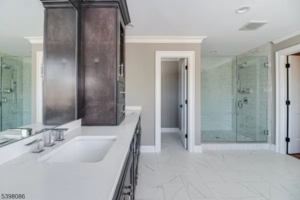 a bathroom with a double vanity sink mirror and shower