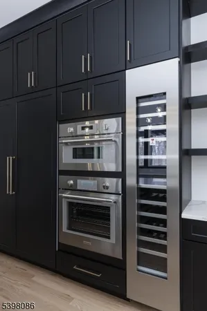 a kitchen with granite countertop stainless steel appliances and cabinets