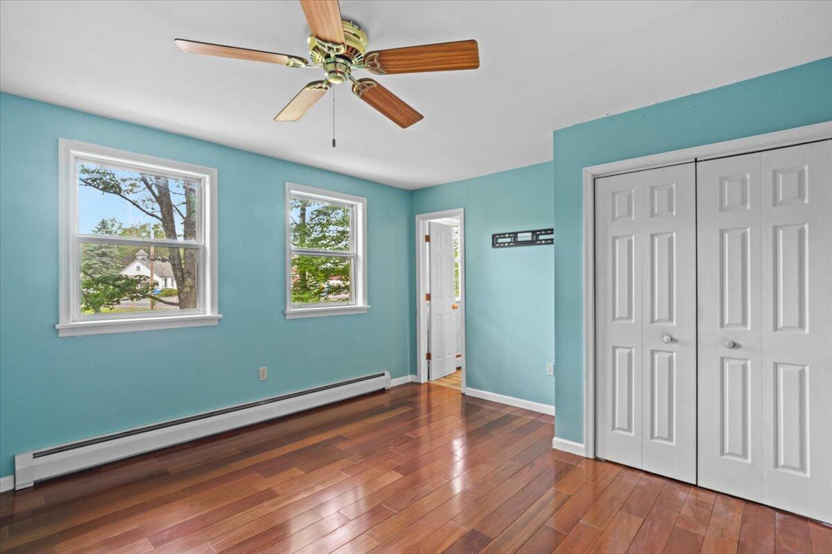 292 Clearview Road Long Pond, PA 18334 - Photo 14 of 33 an empty room with wooden floor ceiling fan and windows