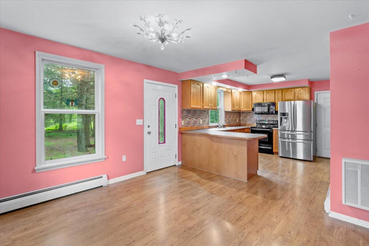 292 Clearview Road Long Pond, PA 18334 - Photo 6 of 33 a kitchen with stainless steel appliances kitchen island granite countertop a refrigerator stove top oven and sink
