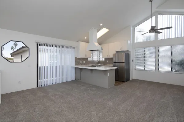 a view of a kitchen with large cabinets and wooden floor
