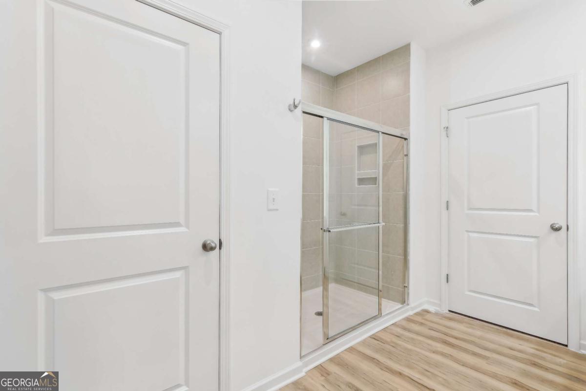 1545 Salinger Court, Unit 1545 Stockbridge, GA 30281 - Photo 12 of 26 a bathroom with a shower and a glass door