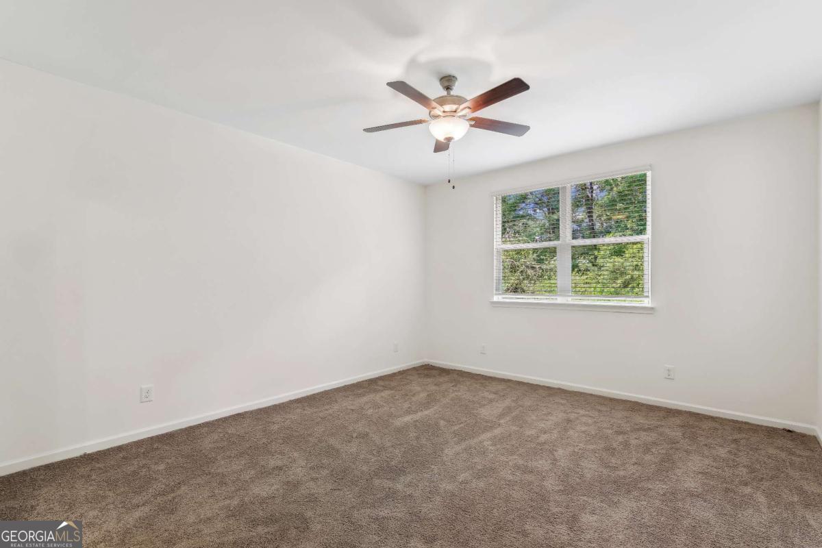 1545 Salinger Court, Unit 1545 Stockbridge, GA 30281 - Photo 16 of 26 an empty room with a window