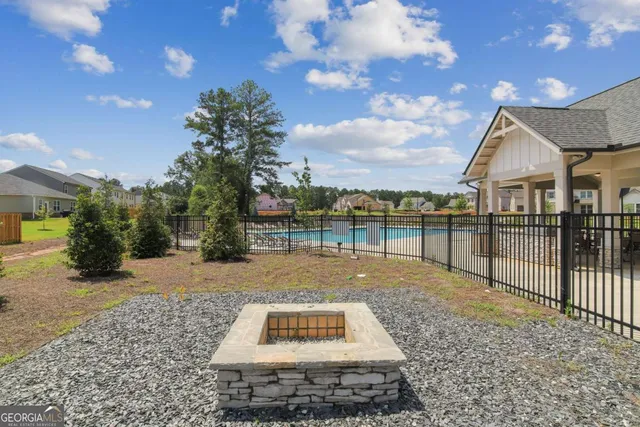 a view of a backyard with sitting area