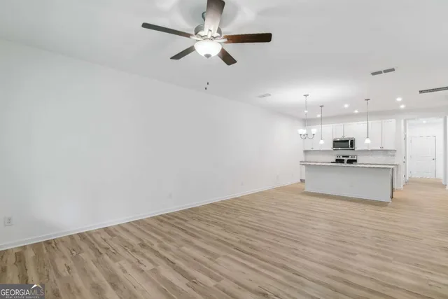 a view of kitchen with microwave and cabinets