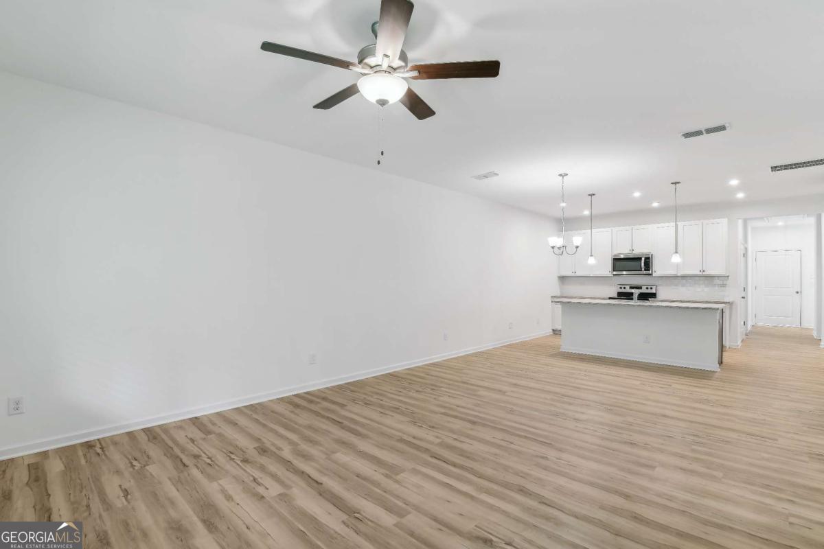 1545 Salinger Court, Unit 1545 Stockbridge, GA 30281 - Photo 5 of 26 a view of kitchen with microwave and cabinets