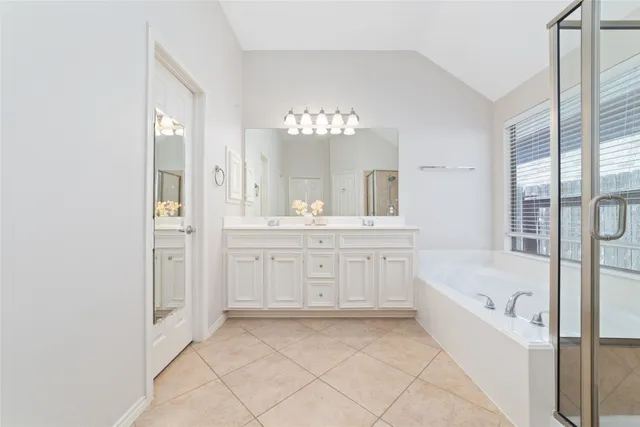 a bathroom with a bathtub sink and a mirror