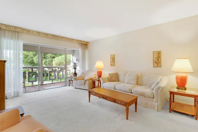 a living room with furniture and a lamp with wooden floor