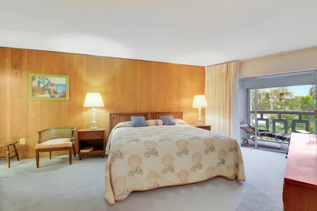 a spacious bedroom with a bed and a couch