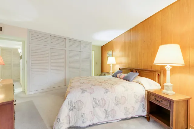 a bedroom with a bed and a lamp