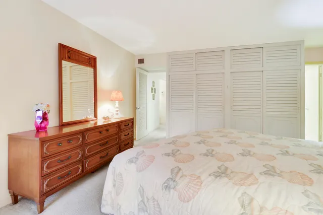 a bedroom with a bed dresser and a window
