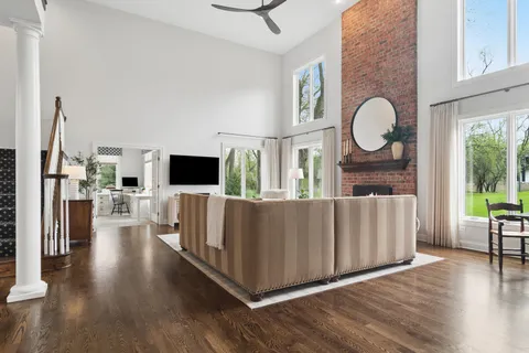 a living room with furniture wooden floor and a flat screen tv
