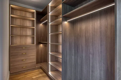a view of walk in closet with empty racks