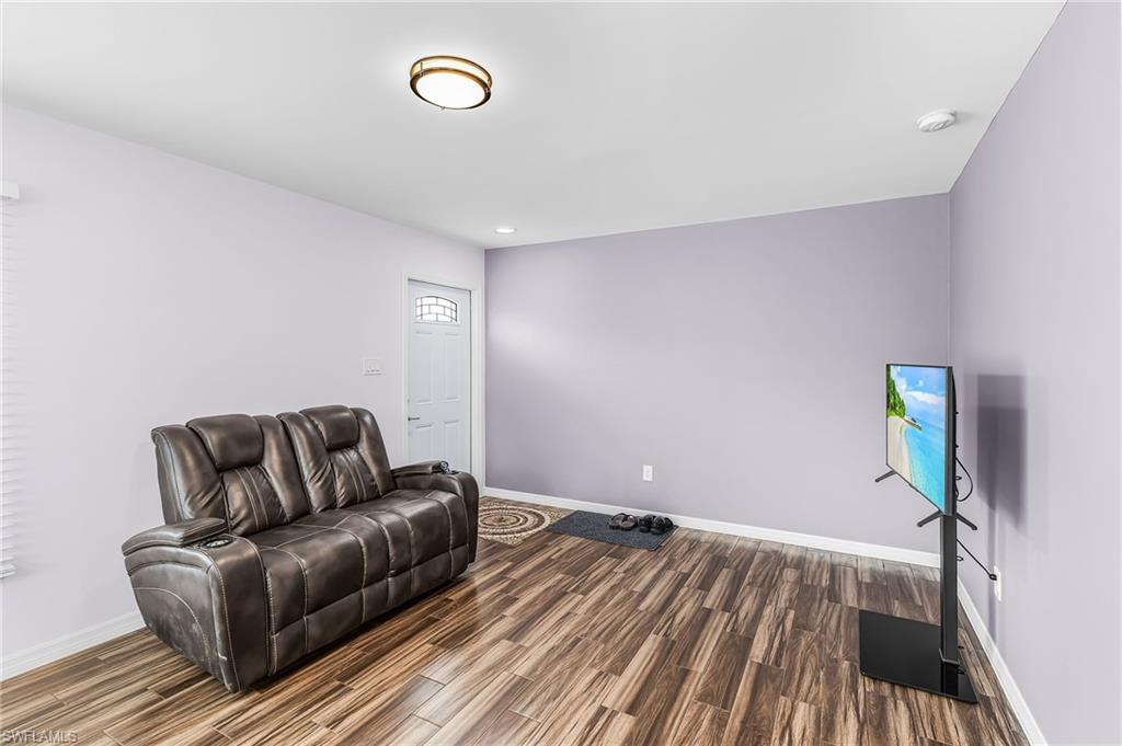 34 Hamlin Court Lehigh Acres, FL 33936 - Photo 8 of 29 a living room with a couch and a rug