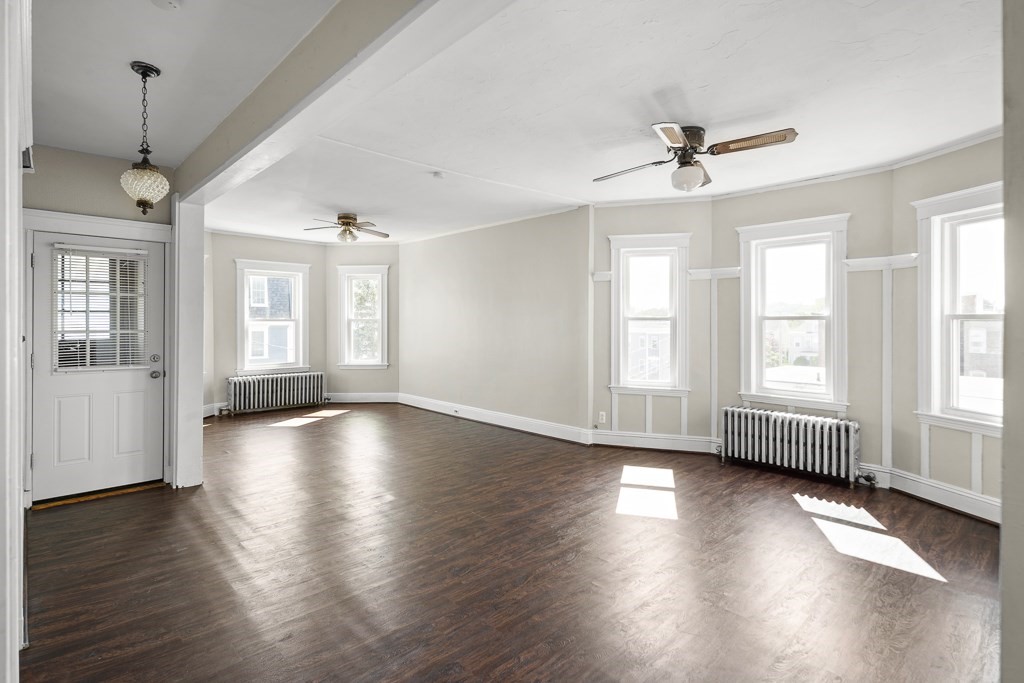 22 Gardena Street, Unit 3 Boston, MA 02135 - Photo 11 of 30 a view of an empty room with wooden floor and a window