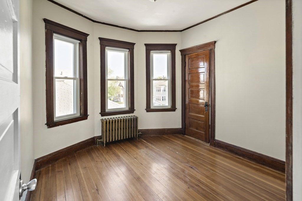 22 Gardena Street, Unit 3 Boston, MA 02135 - Photo 13 of 30 an empty room with wooden floor and windows