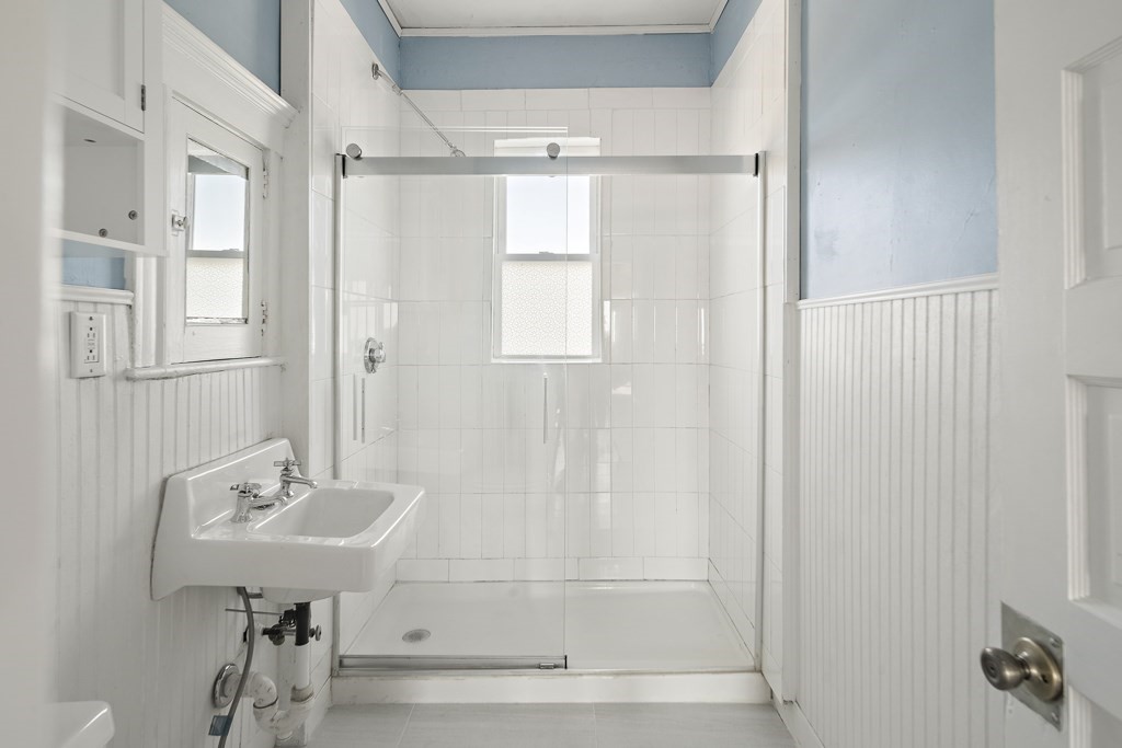 22 Gardena Street, Unit 3 Boston, MA 02135 - Photo 16 of 30 a bathroom with a sink a mirror and a shower
