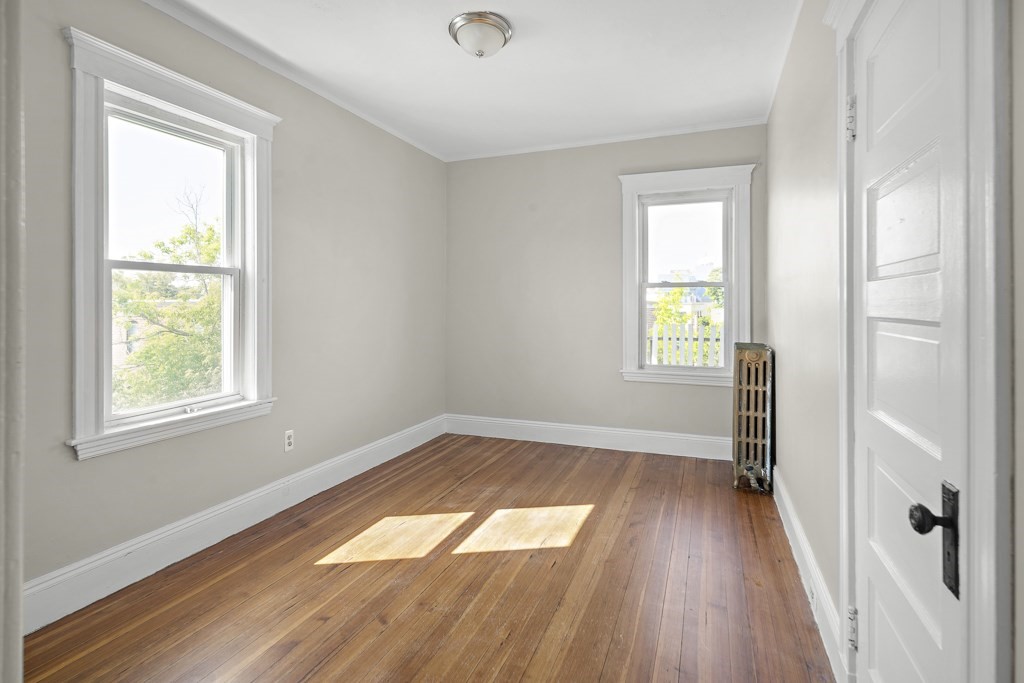 22 Gardena Street, Unit 3 Boston, MA 02135 - Photo 17 of 30 an empty room with wooden floor and windows