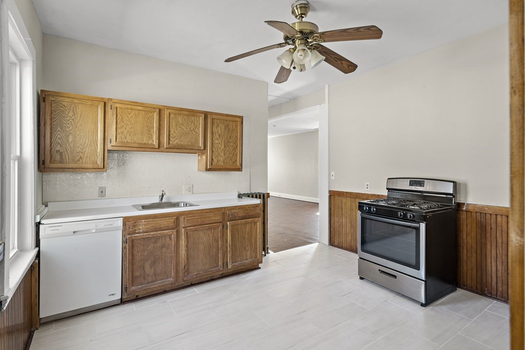 22 Gardena Street, Unit 3 Boston, MA 02135 - Photo 19 of 30 a kitchen with stainless steel appliances granite countertop a sink a stove a microwave and cabinets