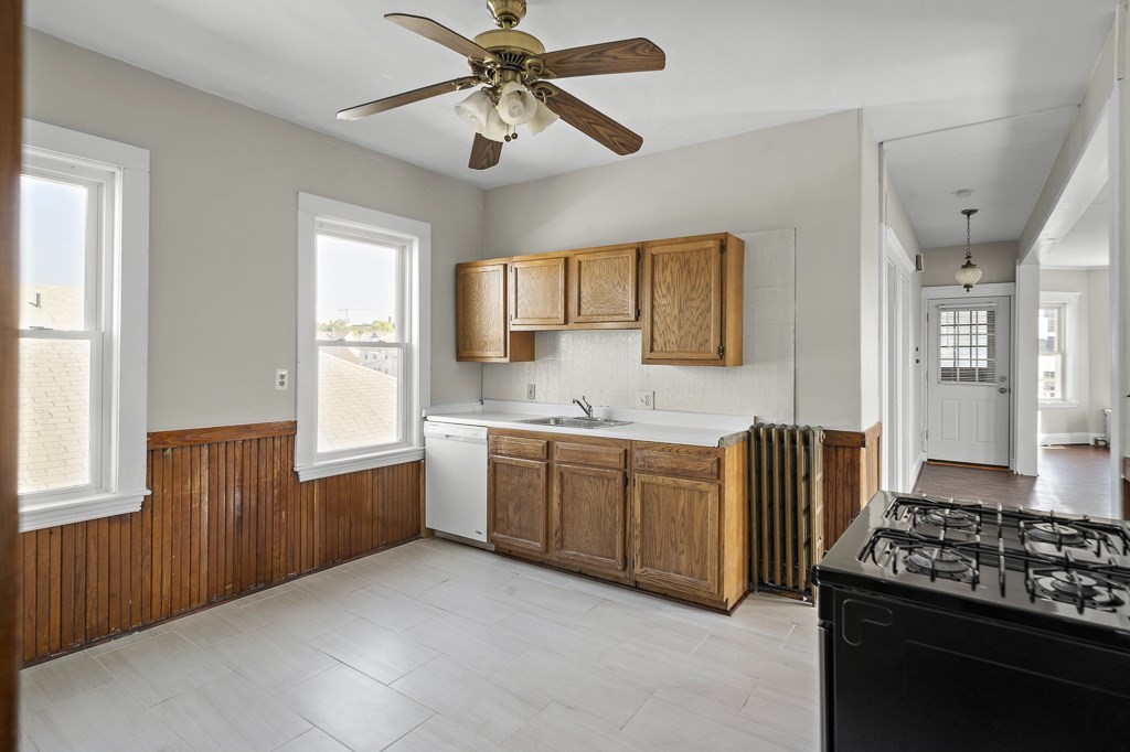 22 Gardena Street, Unit 3 Boston, MA 02135 - Photo 21 of 30 a kitchen with granite countertop a sink cabinets stainless steel appliances and a window