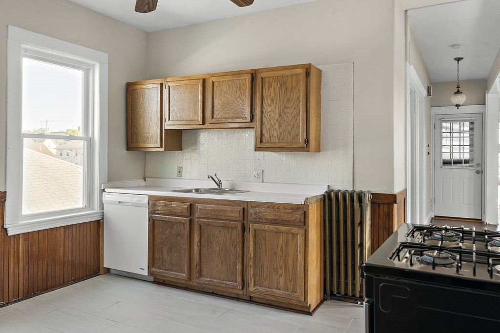 22 Gardena Street, Unit 3 Boston, MA 02135 - Photo 22 of 30 a kitchen with a sink stove and cabinets