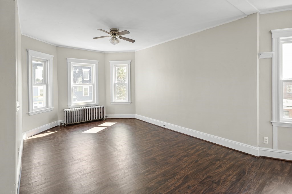 22 Gardena Street, Unit 3 Boston, MA 02135 - Photo 5 of 30 an empty room with wooden floor and windows
