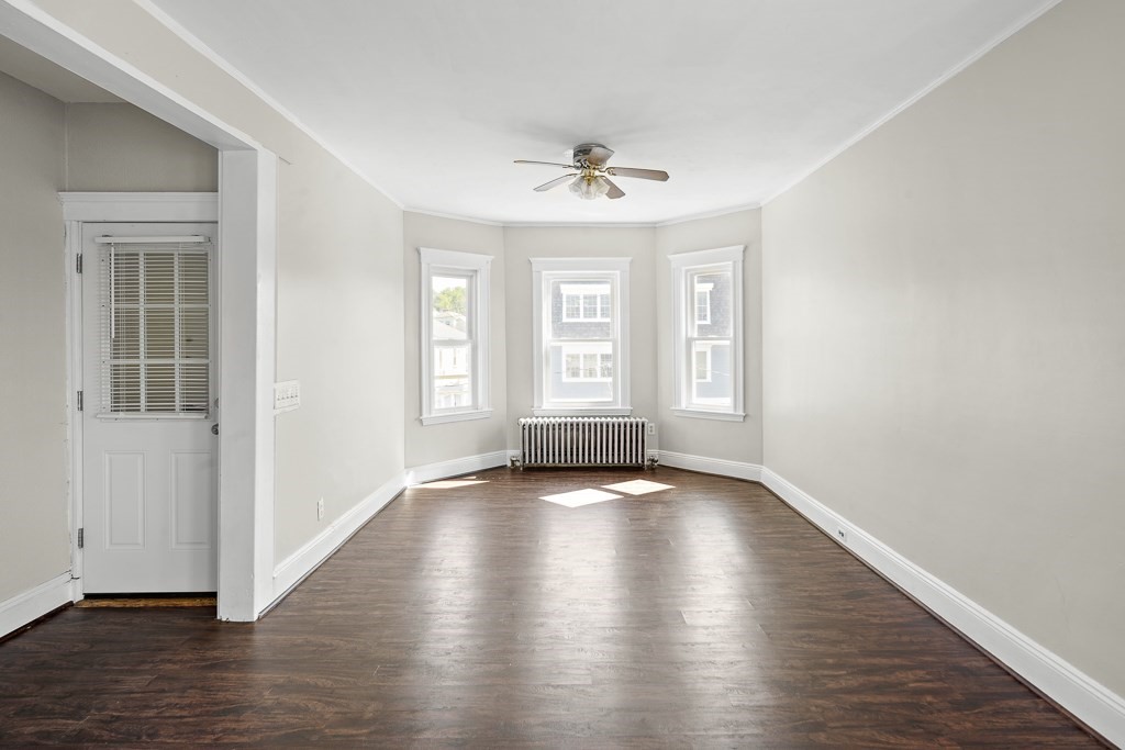 22 Gardena Street, Unit 3 Boston, MA 02135 - Photo 6 of 30 an empty room with wooden floor and windows
