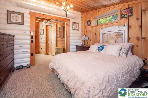 a spacious bedroom with a bed and a window
