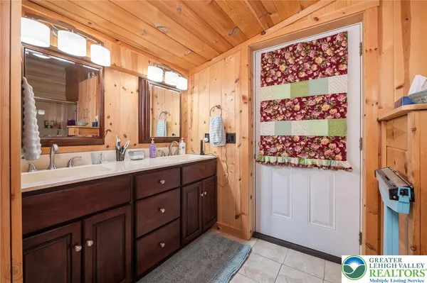 a bathroom with a double vanity sink and mirror