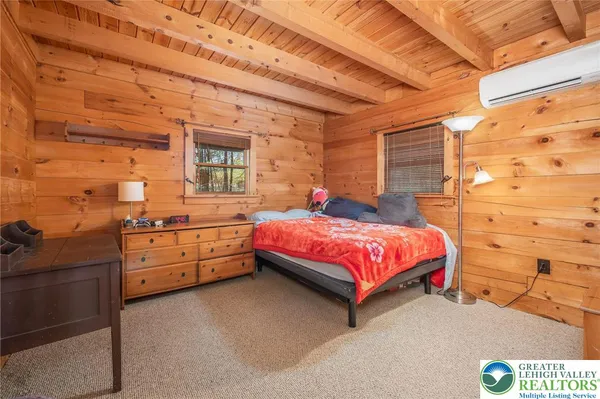 a spacious bedroom with a bed and a dresser
