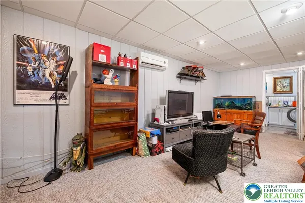 a workspace with furniture cabinet flat screen tv and windows