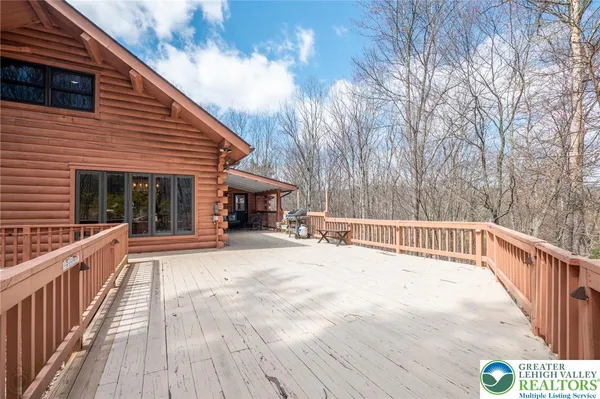 a view of house with backyard and deck