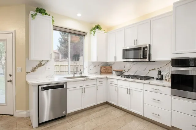 a kitchen with a sink stove and microwave
