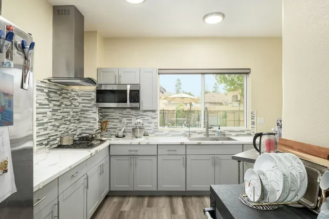 a kitchen with a sink cabinets and window