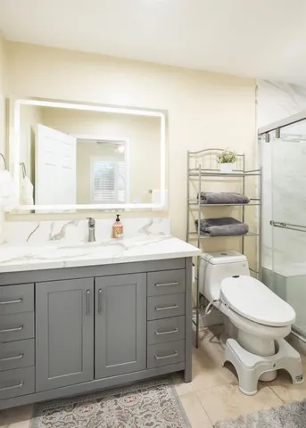 a bathroom with a toilet a sink and mirror