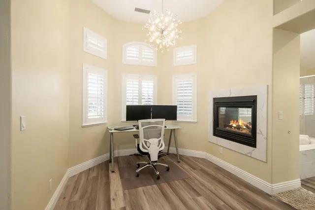 a workspace with wooden floor and a window