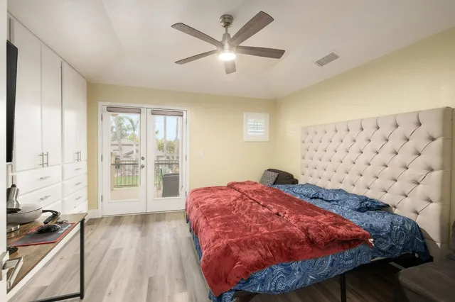 a bed sitting in a bedroom next to a window