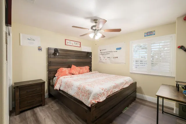 a bed sitting in a bedroom next to a window