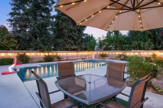 a view of balcony with furniture and umbrella