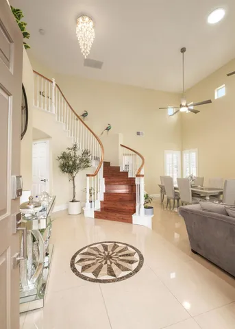 a living room with furniture and a chandelier