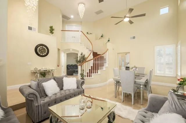 a living room with furniture a rug and a clock