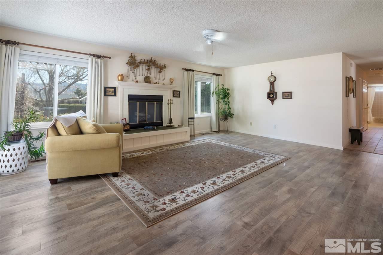 12570 Stillwater Way Reno, NV 89511 - Photo 3 of 29 a living room with furniture and a fireplace