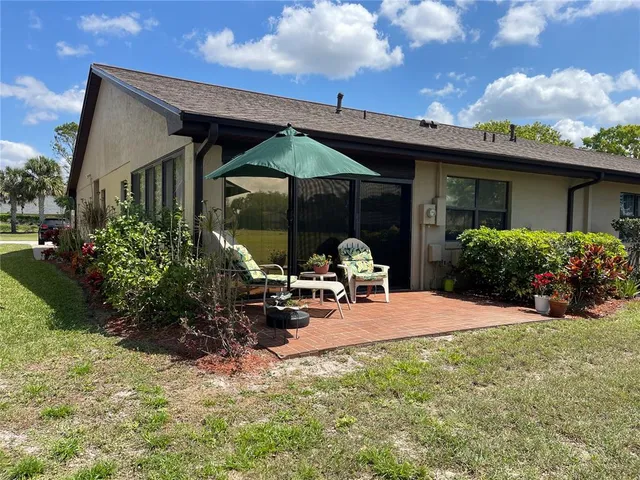 a front view of a house with patio and garden