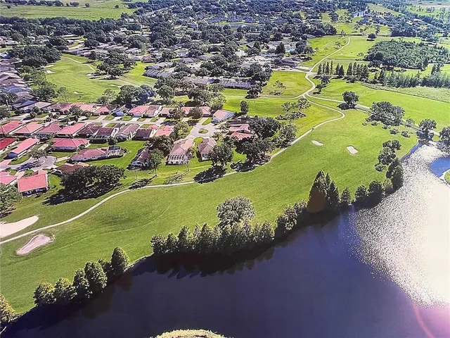 an aerial view of a residential houses with outdoor space swimming pool